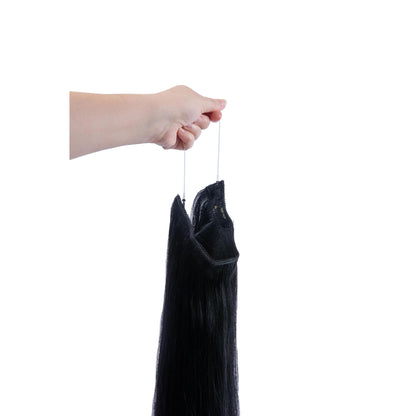 Hand Holding Jet Black (#1) Halo Hair Extensions