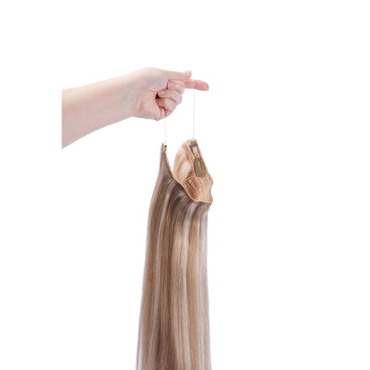 Hand Holding Biscuit Blondey (#18/613) Halo Hair Extensions