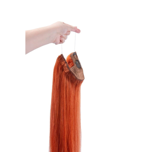 Flaming Ginger (#350) Halo Hair Extensions: hand holding hair extension